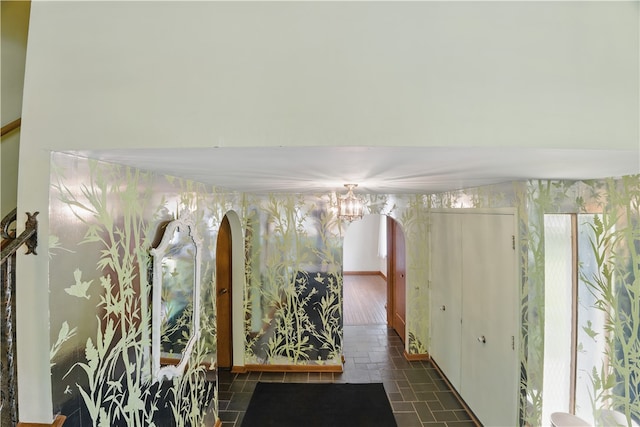 480 Herbst Manor Rd, Kennedy Twp, PA 15108 - hall with a chandelier, arched walkways, stone finish floors, and wallpapered walls