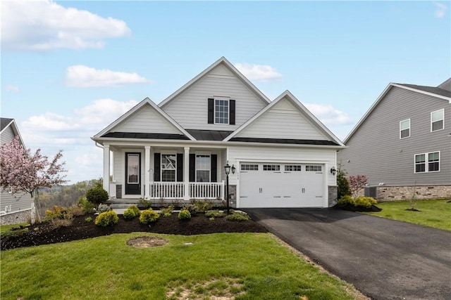 159 Heather Dr, North Strabane, PA 15317 - traditional-style house with driveway, covered porch, a front lawn, and an attached garage