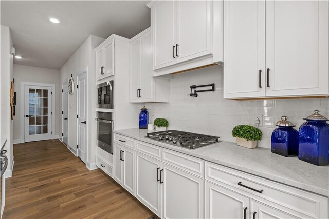 159 Heather Dr, North Strabane, PA 15317 - kitchen featuring stainless steel appliances, white cabinetry, wood finished floors, backsplash, and light stone countertops