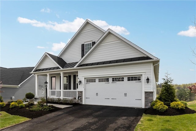 159 Heather Dr, North Strabane, PA 15317 - traditional-style house featuring covered porch, a standing seam roof, driveway, stone siding, and a garage