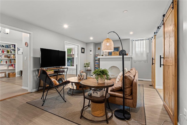 5719 Hobart St, Squirrel Hill, PA 15217 - dining room with a barn door, light wood-type flooring, and recessed lighting