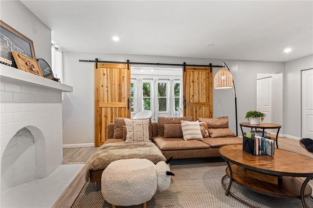 5719 Hobart St, Squirrel Hill, PA 15217 - living room featuring a barn door, recessed lighting, and wood finished floors