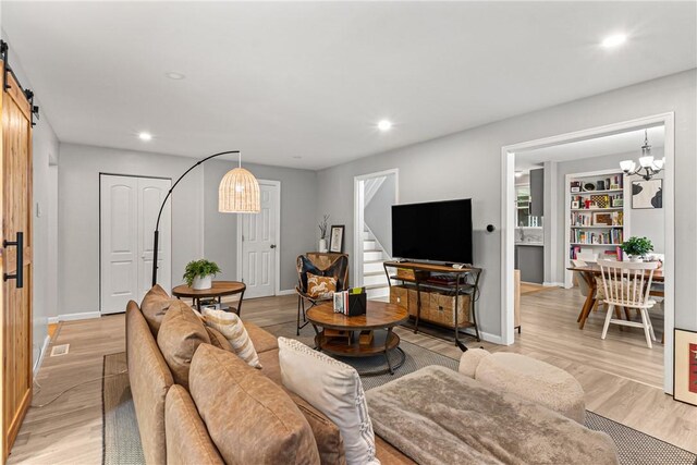 5719 Hobart St, Squirrel Hill, PA 15217 - living area with a chandelier, stairway, light wood-type flooring, recessed lighting, and a barn door