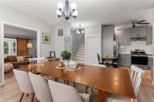 5719 Hobart St, Squirrel Hill, PA 15217 - dining space with a chandelier, stairway, light wood-style floors, and a ceiling fan