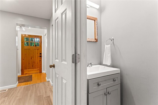 5719 Hobart St, Squirrel Hill, PA 15217 - bathroom featuring wood finished floors, vanity, and ceiling fan