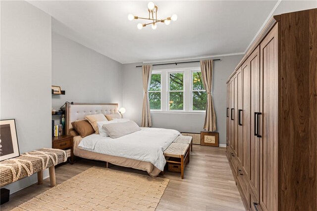 5719 Hobart St, Squirrel Hill, PA 15217 - bedroom with a chandelier and light wood-style flooring