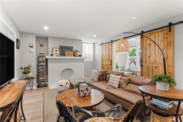 5719 Hobart St, Squirrel Hill, PA 15217 - living area featuring a barn door, light wood-type flooring, and recessed lighting