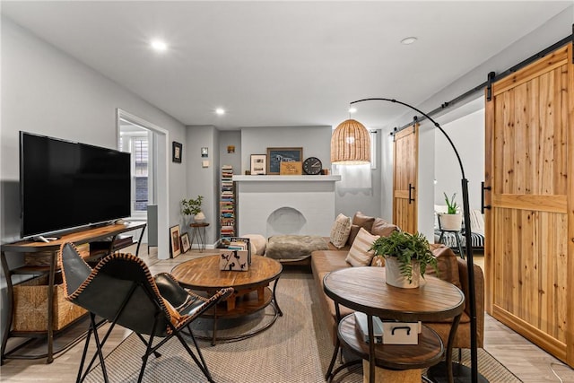 5719 Hobart St, Squirrel Hill, PA 15217 - living room featuring a barn door, light wood-type flooring, and recessed lighting