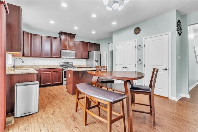 2972 Cross Creek Ct, Hampton, PA 15044 - kitchen with stainless steel appliances, light wood-style flooring, tasteful backsplash, a center island, and recessed lighting