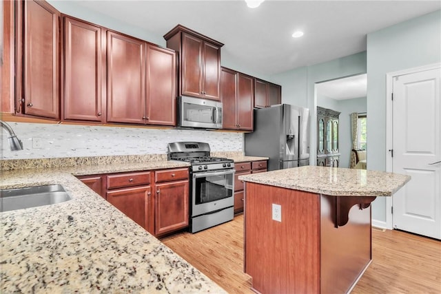 2972 Cross Creek Ct, Hampton, PA 15044 - kitchen featuring appliances with stainless steel finishes, a kitchen island, light wood-type flooring, decorative backsplash, and recessed lighting