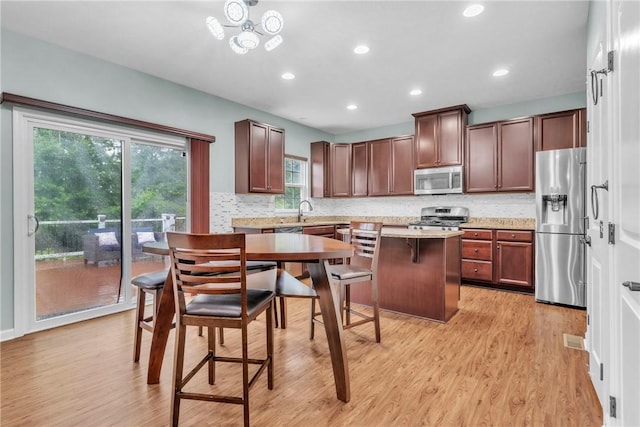 2972 Cross Creek Ct, Hampton, PA 15044 - kitchen with appliances with stainless steel finishes, decorative backsplash, light wood-style flooring, and recessed lighting