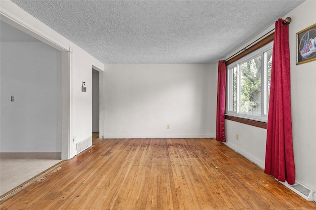 2519 Sylvania Dr, Bethel Park, PA 15102 - empty room with a textured ceiling and hardwood / wood-style floors