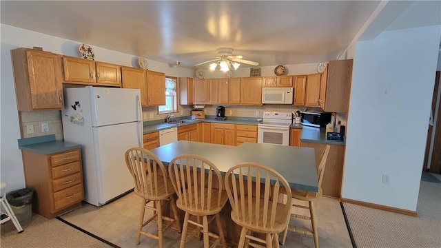287 School Ave, Conemaugh Twp Som, PA 15937 - kitchen with white appliances, ceiling fan, a kitchen bar, and backsplash
