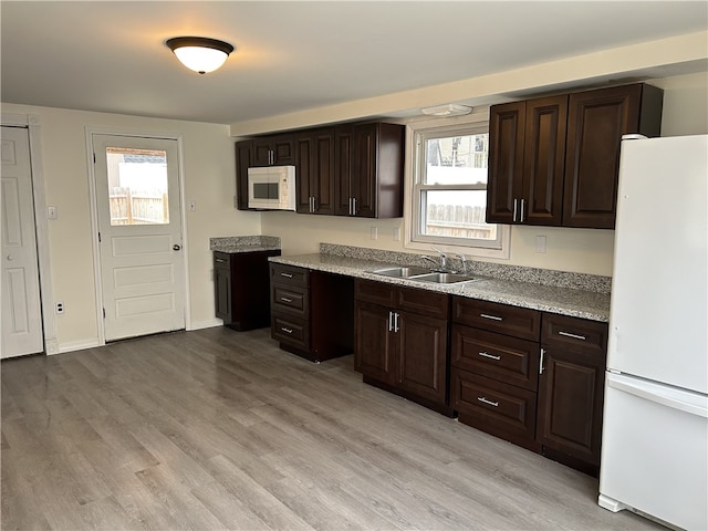 420 28th St, Eastvale, PA 15010 - kitchen featuring white appliances, dark brown cabinets, light wood-style flooring, and light countertops