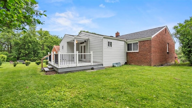 5330 Cox Ave, Lincoln Place, PA 15207 - rear view of property featuring a deck, brick siding, a lawn, and a chimney