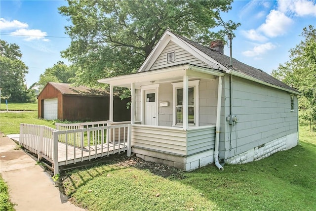 209 George St, Farrell, PA 16121 - view of front facade with a detached garage, a chimney, an outbuilding, a front lawn, and roof with shingles