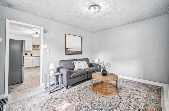 209 George St, Farrell, PA 16121 - living room featuring a textured ceiling and baseboards