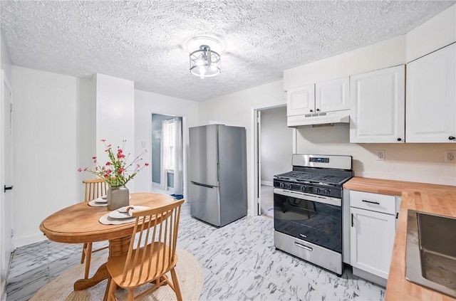 209 George St, Farrell, PA 16121 - kitchen featuring appliances with stainless steel finishes, wooden counters, under cabinet range hood, white cabinets, and a textured ceiling