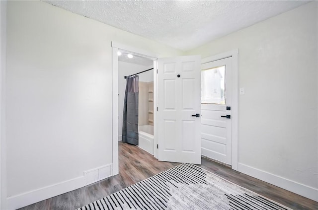 209 George St, Farrell, PA 16121 - unfurnished bedroom featuring wood finished floors and a textured ceiling