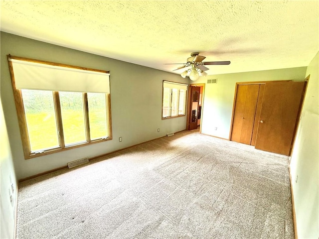 155 Anoka, Neshannock Twp, PA 16105 - unfurnished bedroom featuring multiple windows, carpet floors, a textured ceiling, a closet, and ceiling fan