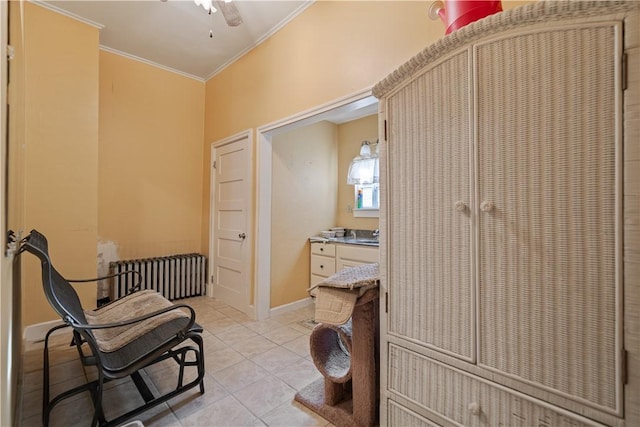 2403 Jenny Lind St, Mckeesport, PA 15132 - laundry room featuring radiator, crown molding, a ceiling fan, and light tile patterned floors