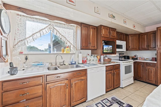 2403 Jenny Lind St, Mckeesport, PA 15132 - kitchen featuring white appliances, light tile patterned floors, light countertops, and brown cabinets