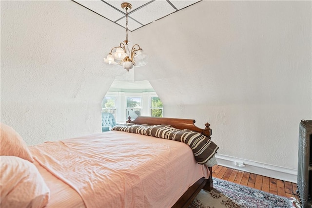 2403 Jenny Lind St, Mckeesport, PA 15132 - bedroom featuring hardwood / wood-style flooring, a chandelier, vaulted ceiling, and a textured wall
