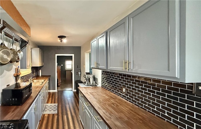 1235 Arkansas Ave, Dormont, PA 15216 - kitchen with wooden counters, black microwave, gray cabinetry, dark wood-style floors, and decorative backsplash