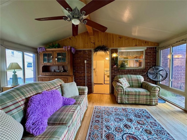 111 Greenview Dr, Verona, PA 15147 - living area with light wood finished floors, ceiling fan, and wooden walls