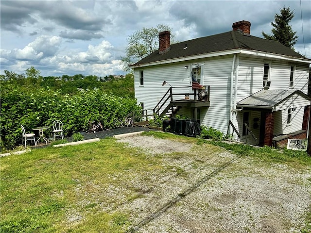 1879 Romine Ave, Port Vue, PA 15133 - rear view of property with a chimney and a lawn