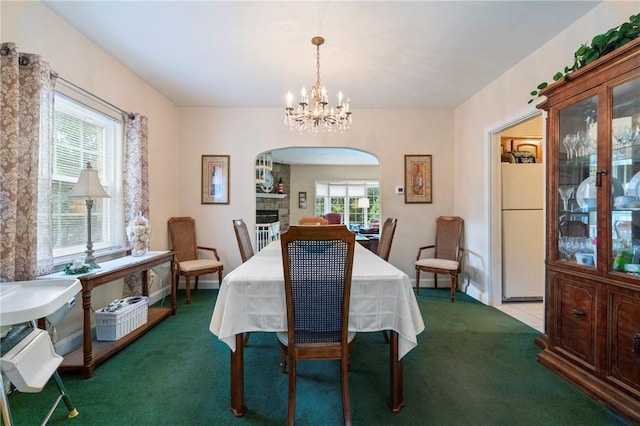 517 Keystone Dr, New Kensington, PA 15068 - carpeted dining area featuring arched walkways and a chandelier