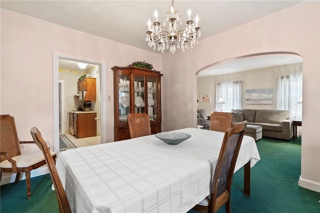 517 Keystone Dr, New Kensington, PA 15068 - carpeted dining room with arched walkways and a chandelier