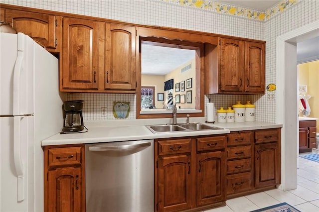517 Keystone Dr, New Kensington, PA 15068 - kitchen featuring stainless steel dishwasher, freestanding refrigerator, tasteful backsplash, and light countertops