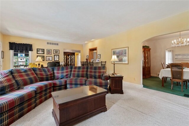 517 Keystone Dr, New Kensington, PA 15068 - carpeted living area with arched walkways, a chandelier, and plenty of natural light