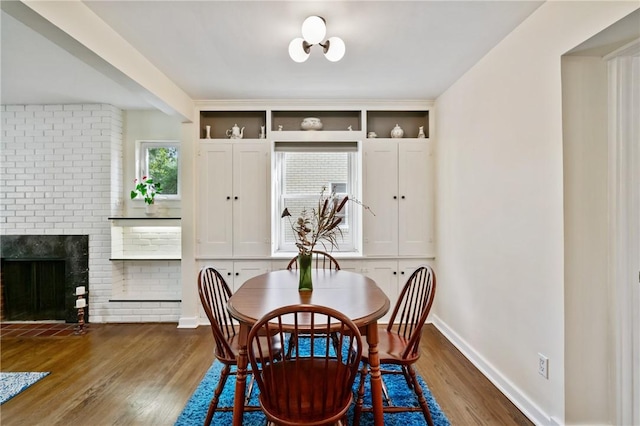1333 Windermere Dr, Squirrel Hill, PA 15218 - dining room featuring wood finished floors and a brick fireplace