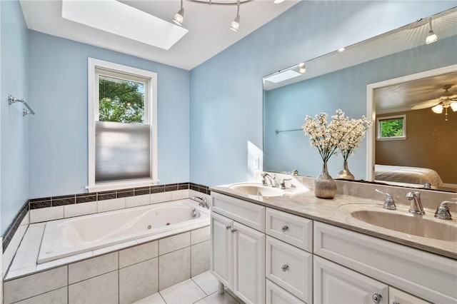 1333 Windermere Dr, Squirrel Hill, PA 15218 - ensuite bathroom with plenty of natural light, double vanity, a tub with jets, and a skylight