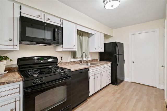 1333 Windermere Dr, Squirrel Hill, PA 15218 - kitchen featuring black appliances, light wood-style floors, and white cabinets