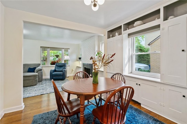 1333 Windermere Dr, Squirrel Hill, PA 15218 - dining area featuring a fireplace and wood finished floors