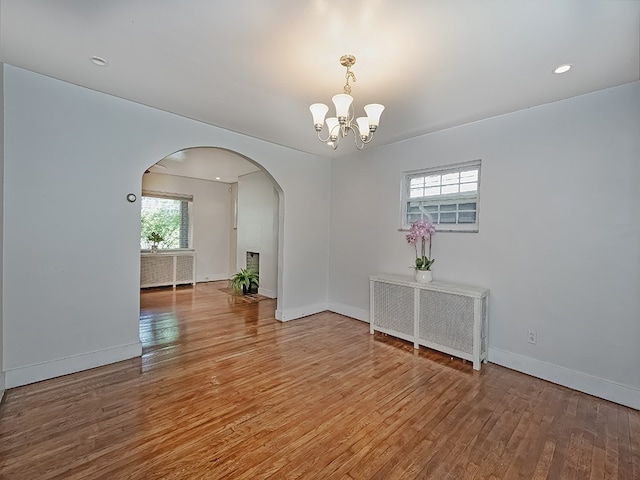 6656 Wilkins Ave, Squirrel Hill, PA 15217 - unfurnished room with arched walkways, a chandelier, radiator heating unit, wood finished floors, and recessed lighting