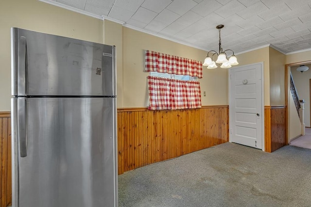 1621 4th St, New Brighton, PA 15066 - unfurnished dining area with a wainscoted wall, ornamental molding, a chandelier, carpet flooring, and wood walls