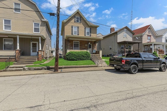 1621 4th St, New Brighton, PA 15066 - view of front facade with a porch, stairs, and board and batten siding