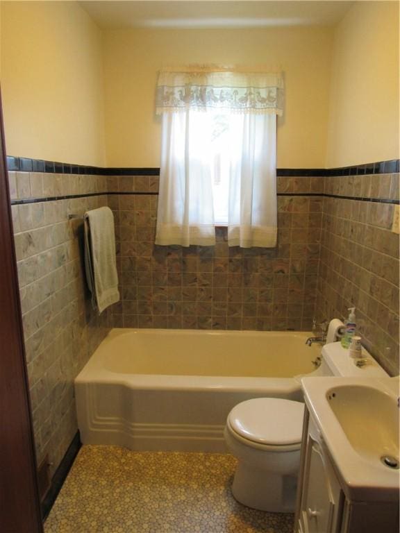 1764 Rose St, Lower Burrell, PA 15068 - full bath with tile walls, a tub to relax in, vanity, and wainscoting