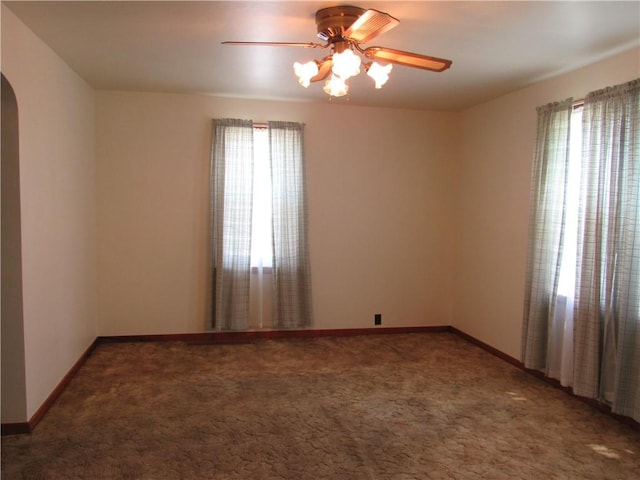 1764 Rose St, Lower Burrell, PA 15068 - empty room featuring healthy amount of natural light, a ceiling fan, arched walkways, and carpet floors