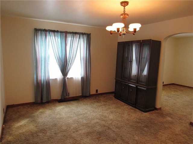 1764 Rose St, Lower Burrell, PA 15068 - spare room featuring arched walkways, a chandelier, and light colored carpet