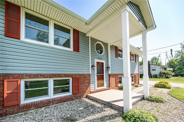 453 Falls Ave, Neshannock Twp, PA 16105 - view of exterior entry featuring brick siding and a porch