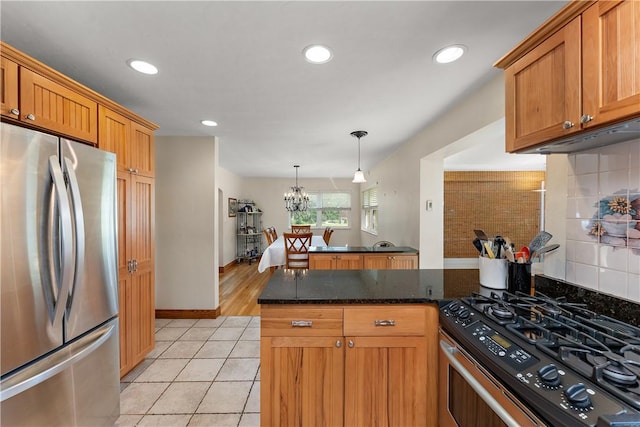 1922 Shady Oak Dr, Mccandless, PA 15101 - kitchen with stainless steel appliances, a peninsula, light tile patterned floors, tasteful backsplash, and dark stone counters