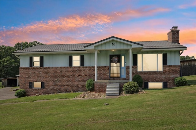 379 Airport Rd, Worthington, PA 16262 - view of front of home with brick siding, a front lawn, a chimney, and a metal roof