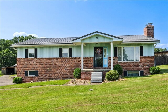 379 Airport Rd, Worthington, PA 16262 - view of front of home with a front lawn, brick siding, a chimney, and a metal roof