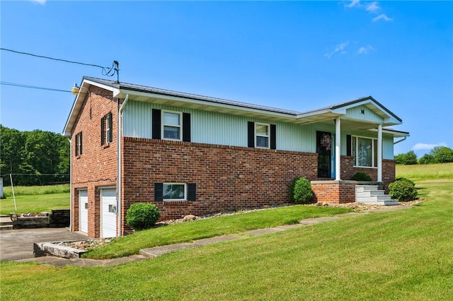 379 Airport Rd, Worthington, PA 16262 - view of front of house featuring an attached garage, asphalt driveway, brick siding, and a front lawn