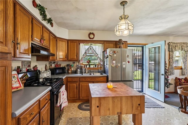 379 Airport Rd, Worthington, PA 16262 - kitchen with gas stove, freestanding refrigerator, under cabinet range hood, and plenty of natural light